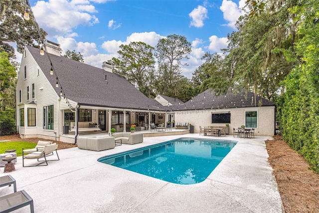 view of swimming pool with an outdoor living space and a patio