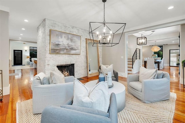 living room featuring a stone fireplace and light wood-type flooring