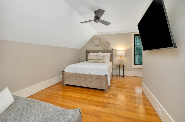 bedroom with ceiling fan, lofted ceiling, and hardwood / wood-style flooring