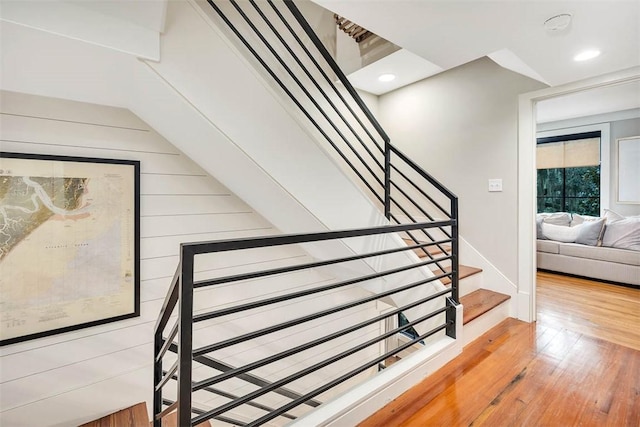 stairway with hardwood / wood-style floors