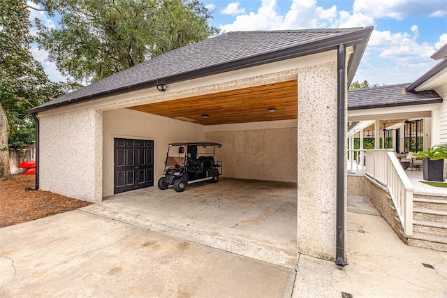 garage featuring a porch and a carport