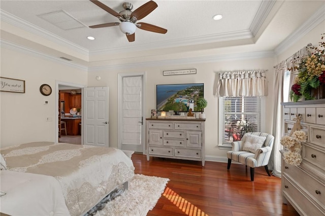 bedroom featuring a tray ceiling, dark wood-type flooring, ornamental molding, and ceiling fan