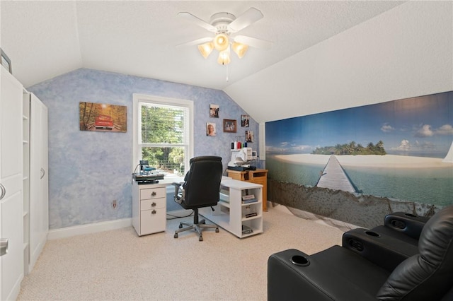 carpeted home office with ceiling fan, vaulted ceiling, and a textured ceiling