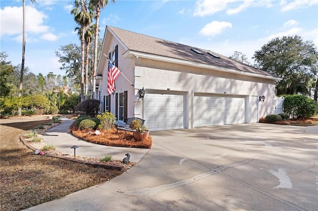 view of side of home featuring a garage