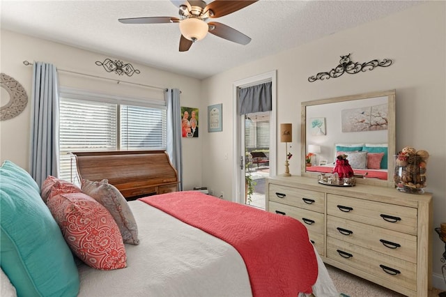 carpeted bedroom featuring a textured ceiling and ceiling fan