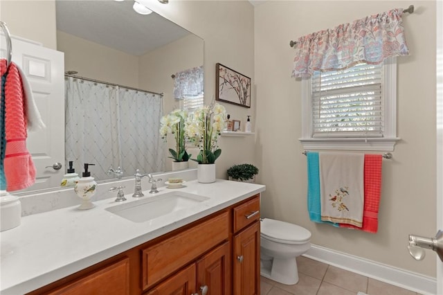 bathroom featuring tile patterned flooring, vanity, and toilet