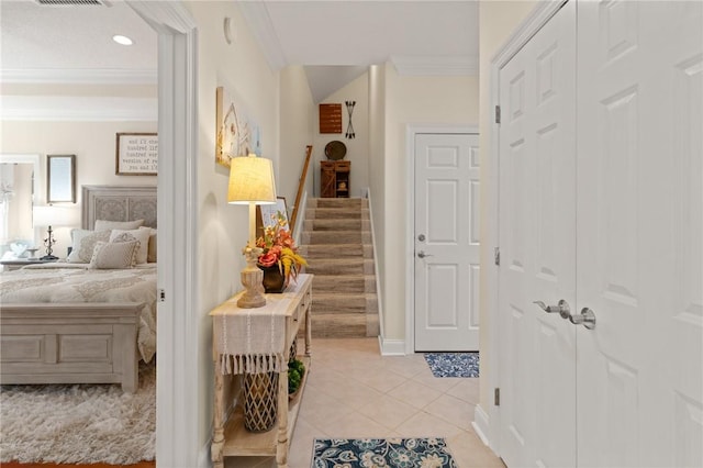 hall with crown molding and light tile patterned flooring