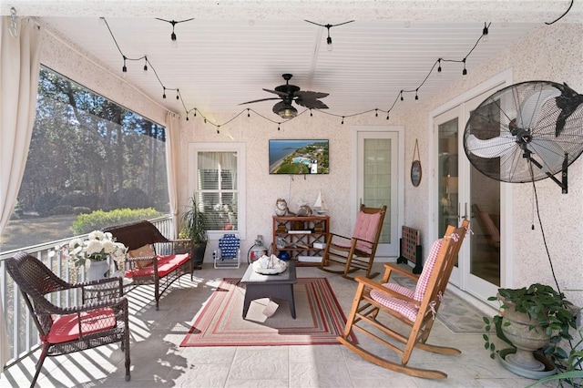 sunroom / solarium featuring ceiling fan