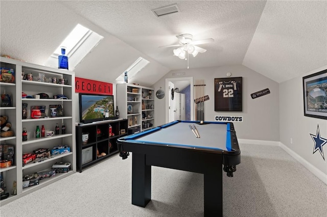 playroom featuring a textured ceiling, carpet floors, and vaulted ceiling with skylight