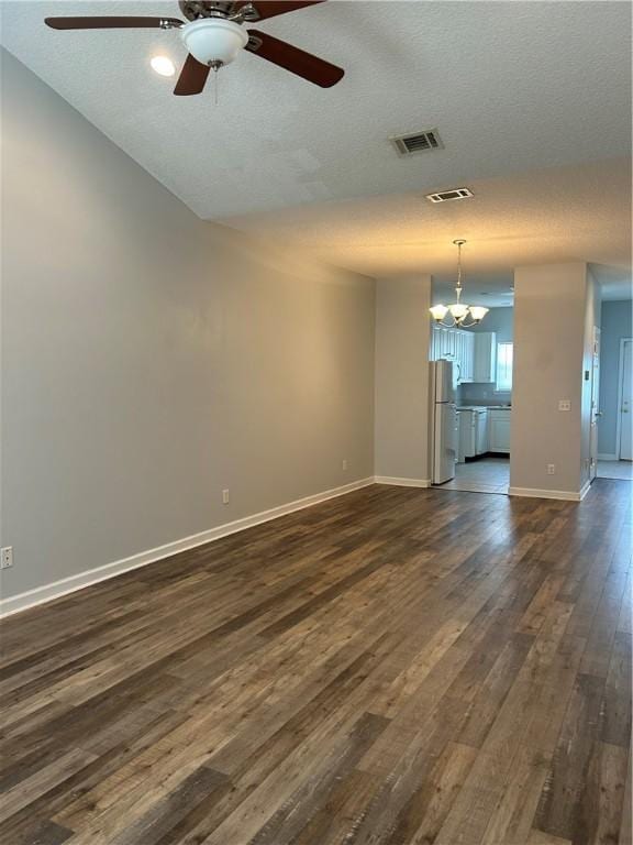366 Moss Creek Ln, Brunswick, GA 31520 - spare room with ceiling fan, dark wood-style floors, a textured ceiling, and a chandelier