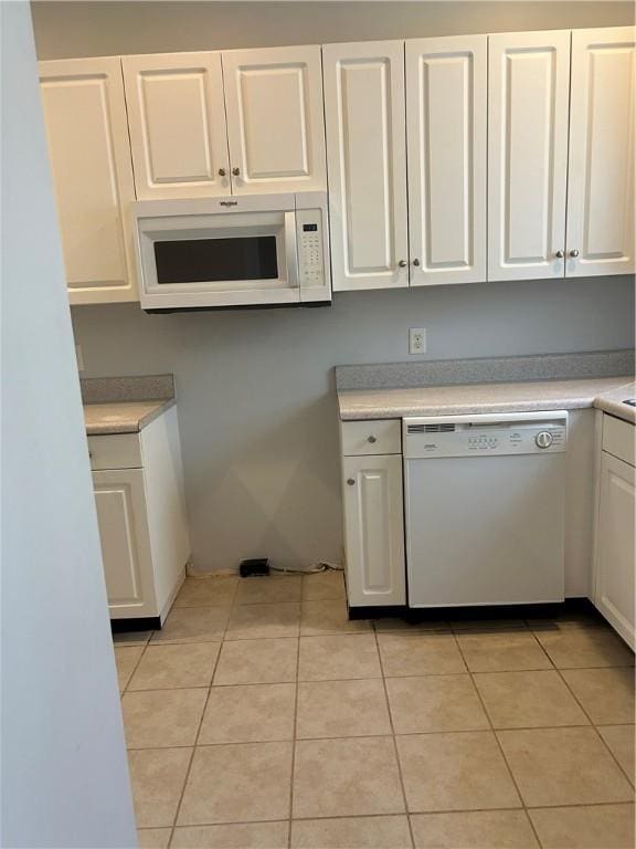 366 Moss Creek Ln, Brunswick, GA 31520 - kitchen with white appliances, white cabinetry, light countertops, and light tile patterned floors