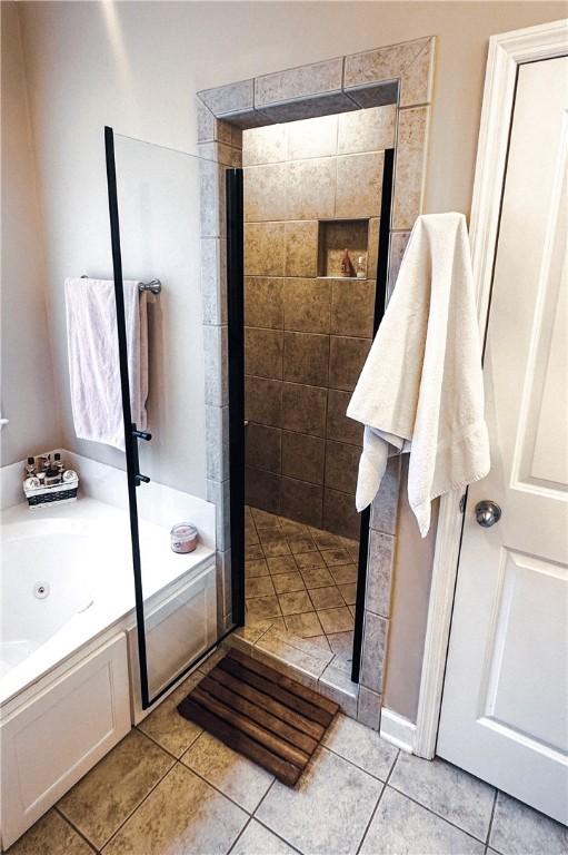 full bath featuring tile patterned floors, a stall shower, and a whirlpool tub