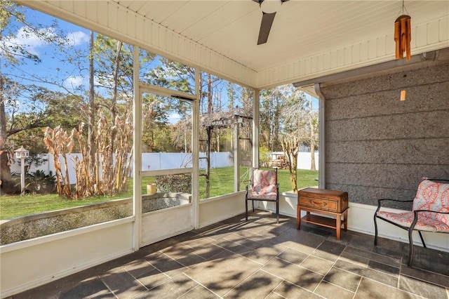 sunroom / solarium featuring ceiling fan