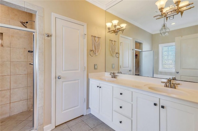 bathroom featuring a sink, a notable chandelier, a stall shower, and ornamental molding