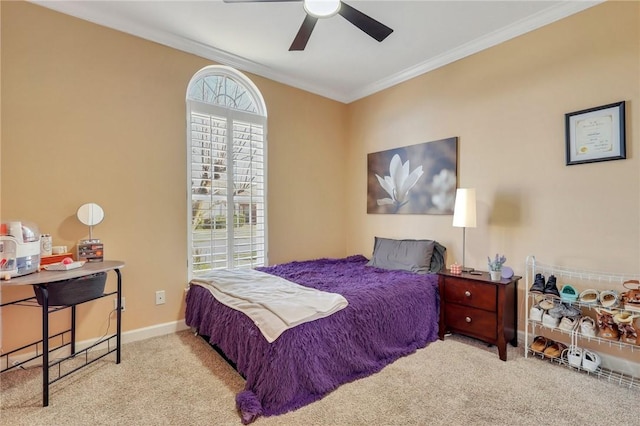 carpeted bedroom featuring crown molding, baseboards, and ceiling fan