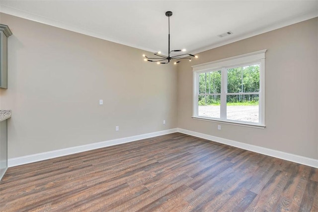 94 Silver Bluff Dr, Brunswick, GA 31523 - spare room with a chandelier and dark wood-type flooring