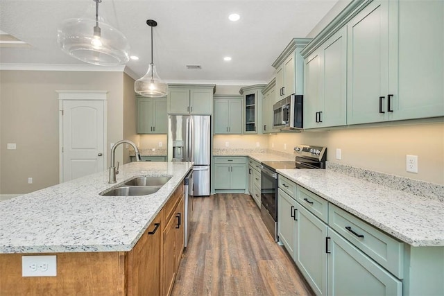 94 Silver Bluff Dr, Brunswick, GA 31523 - kitchen with stainless steel appliances, dark wood-style floors, crown molding, a kitchen island with sink, and light stone counters