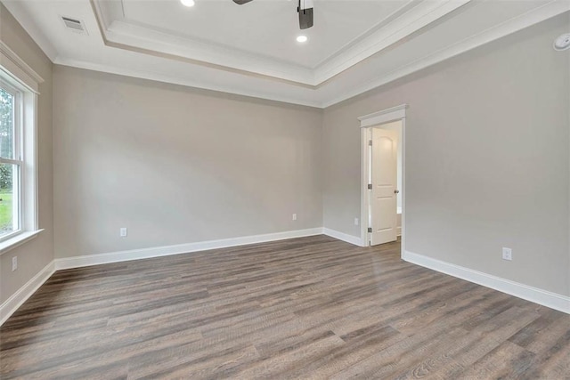 94 Silver Bluff Dr, Brunswick, GA 31523 - empty room with a tray ceiling, plenty of natural light, crown molding, dark wood-style flooring, and ceiling fan