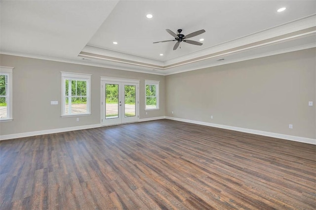 94 Silver Bluff Dr, Brunswick, GA 31523 - empty room featuring ornamental molding, healthy amount of natural light, dark wood-type flooring, a tray ceiling, and recessed lighting