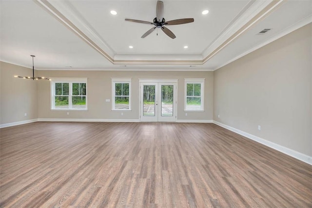 94 Silver Bluff Dr, Brunswick, GA 31523 - unfurnished room featuring a raised ceiling, crown molding, a chandelier, wood finished floors, and ceiling fan