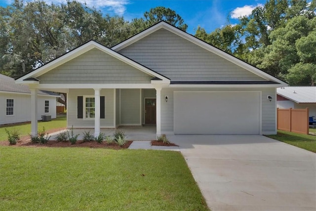 view of front facade featuring central AC unit, a porch, a garage, and a front yard