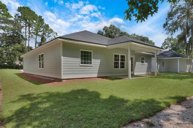 rear view of property with a lawn