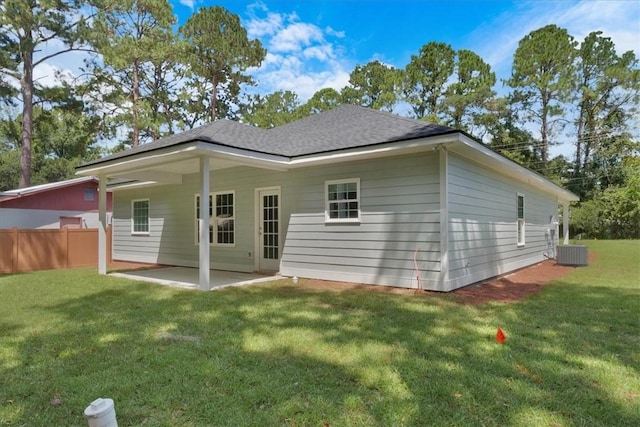 rear view of property featuring a lawn and a patio