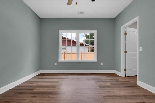 empty room with hardwood / wood-style flooring and ceiling fan