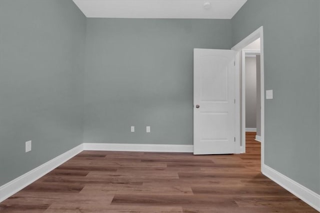 spare room with hardwood / wood-style floors