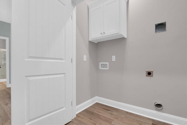 laundry room featuring light hardwood / wood-style flooring, cabinets, and hookup for an electric dryer