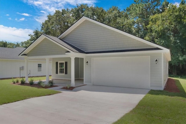 view of front of property featuring a porch, a garage, and a front lawn