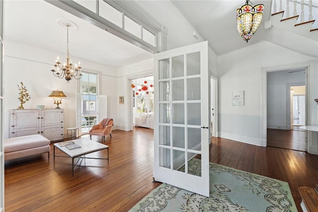 living room with hardwood / wood-style floors and an inviting chandelier