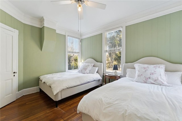 bedroom featuring ceiling fan, ornamental molding, and dark hardwood / wood-style floors