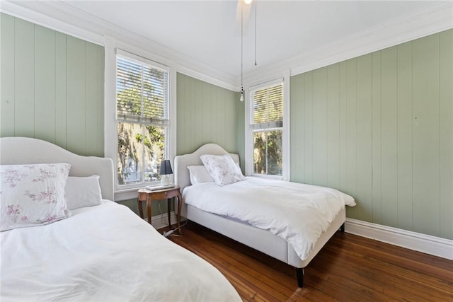 bedroom with ceiling fan, multiple windows, dark hardwood / wood-style flooring, and ornamental molding