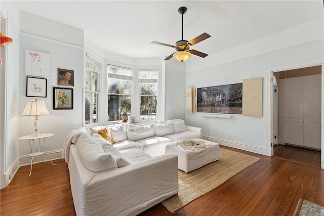 living room with dark hardwood / wood-style floors and ceiling fan