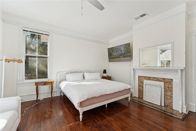 bedroom with ceiling fan, dark hardwood / wood-style floors, and crown molding