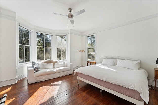 bedroom featuring crown molding, ceiling fan, and dark hardwood / wood-style flooring