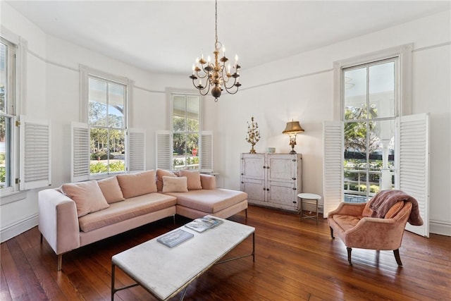 living room featuring dark hardwood / wood-style floors, a chandelier, and a healthy amount of sunlight