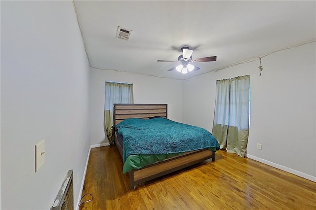 2867 Evergreen Rd, Waycross, GA 31501 - bedroom with wood finished floors, a ceiling fan, and multiple windows