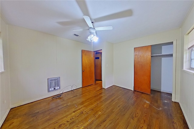 2867 Evergreen Rd, Waycross, GA 31501 - unfurnished bedroom with wood finished floors, a ceiling fan, a closet, and heating unit