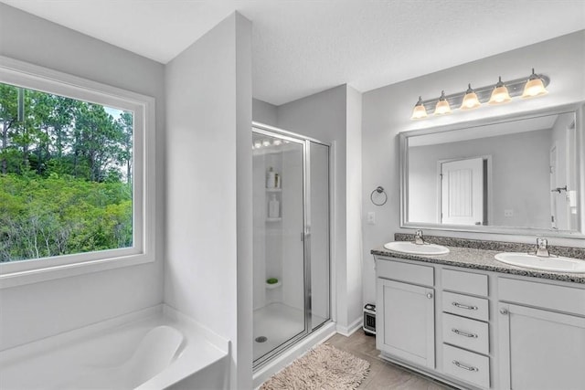 592 Brightleaf Cir, Hinesville, GA 31313 - bathroom with plenty of natural light, a shower stall, double vanity, and a garden tub