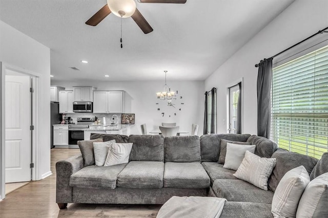 592 Brightleaf Cir, Hinesville, GA 31313 - living room with a chandelier, a ceiling fan, light wood-type flooring, and recessed lighting