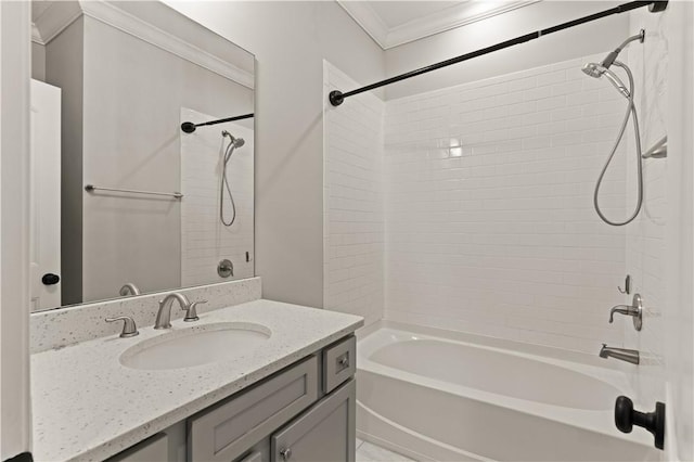 bathroom with vanity, ornamental molding, and tiled shower / bath