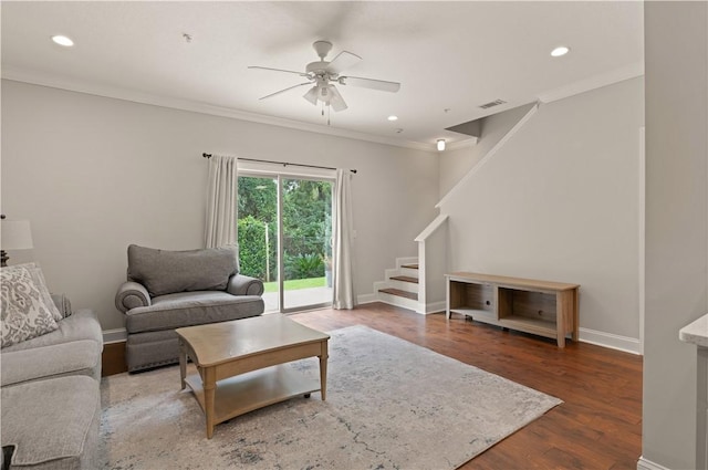 living room featuring hardwood / wood-style floors, ceiling fan, and crown molding