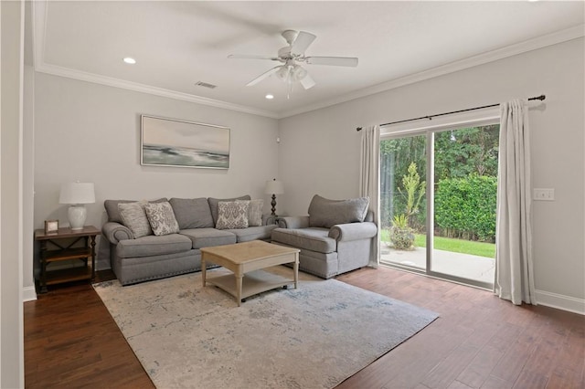 living room with dark hardwood / wood-style flooring, ceiling fan, and crown molding