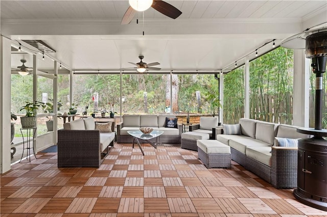 unfurnished sunroom with ceiling fan and a healthy amount of sunlight