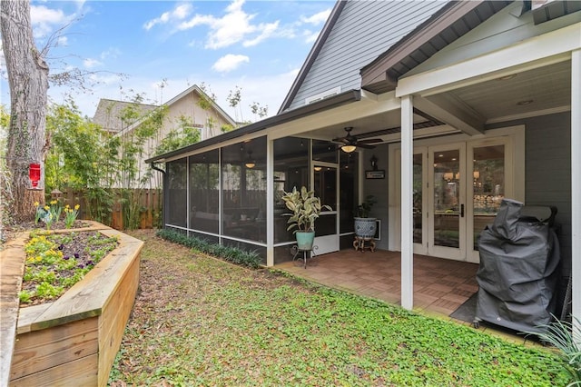 view of yard featuring ceiling fan, a sunroom, and a patio