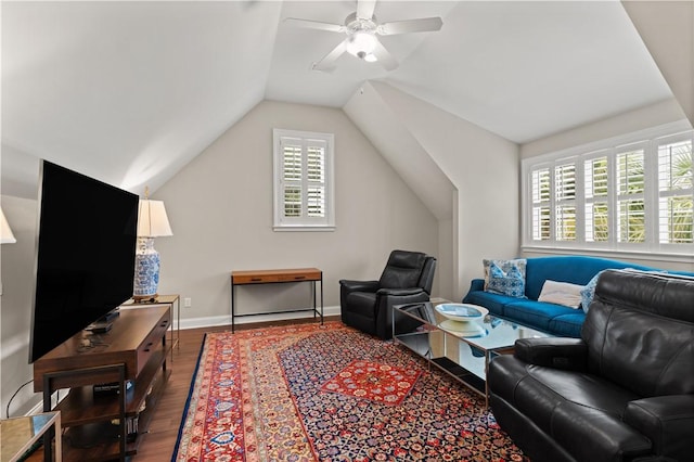 living room with dark wood-type flooring, ceiling fan, and vaulted ceiling