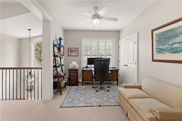 office space featuring ceiling fan with notable chandelier and carpet floors