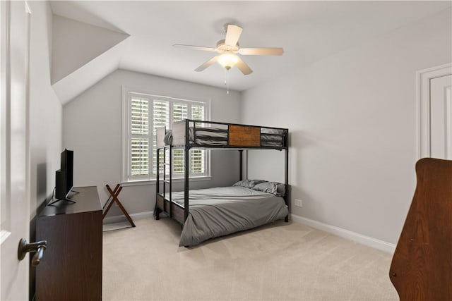 carpeted bedroom featuring lofted ceiling and ceiling fan